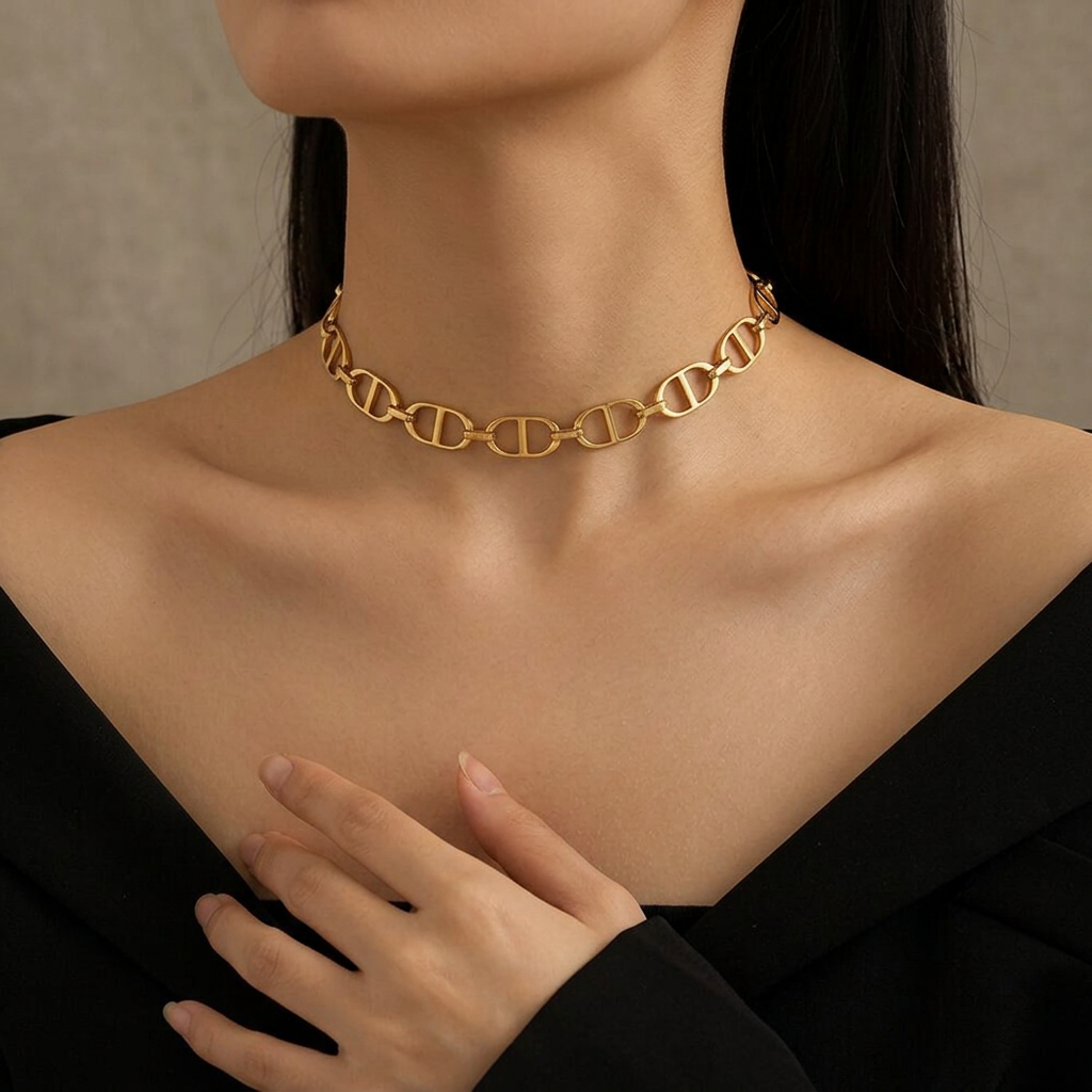 Model wearing a gold CD open-link choker at the base of the neck.