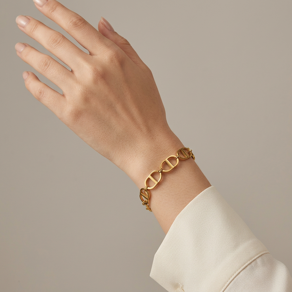 Close-up of a wrist wearing a gold CD open-link bracelet.