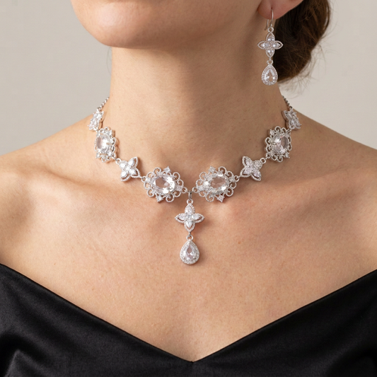 Matching silver clear crystal necklace and teardrop earrings worn together