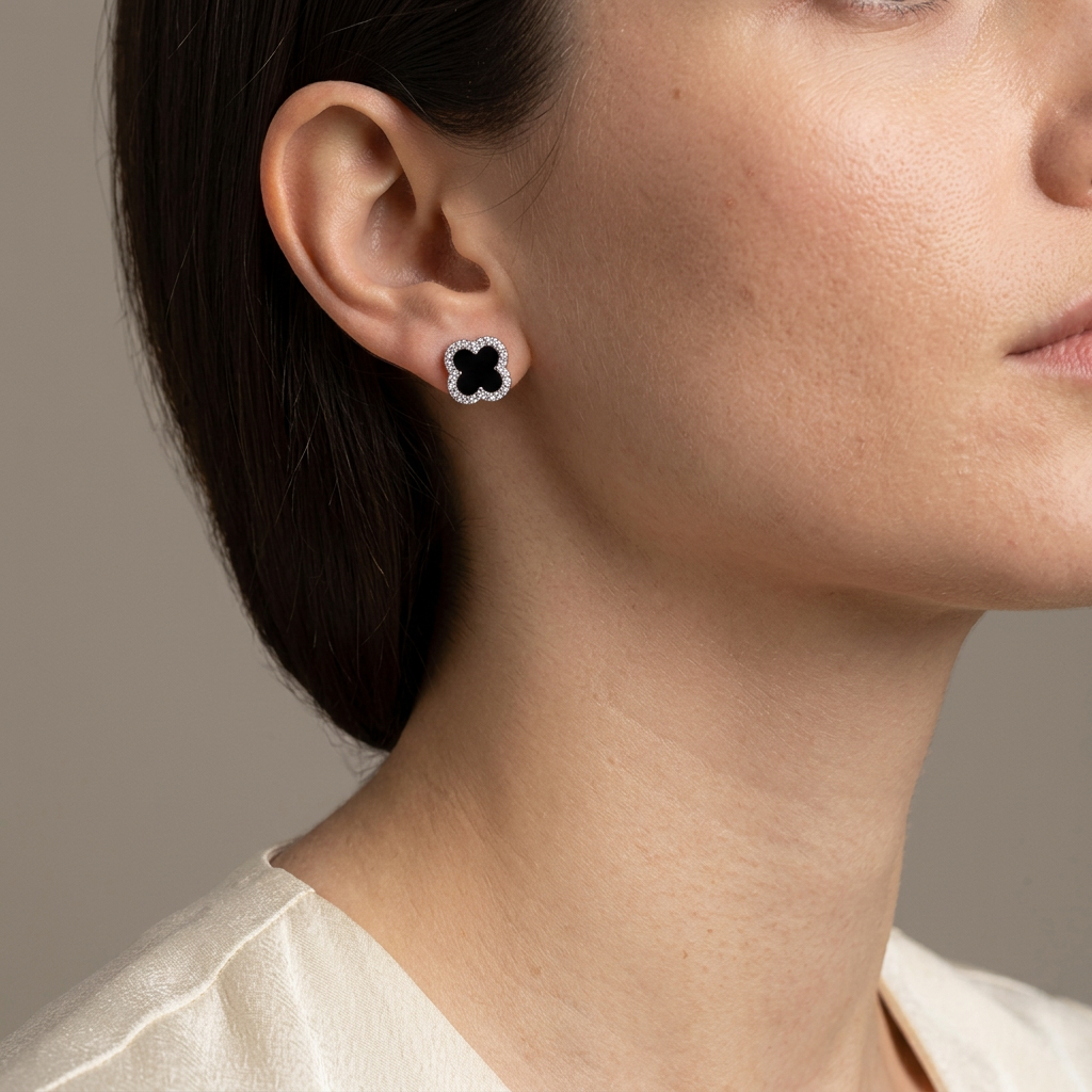 Black clover CZ stud earring worn by a model against a warm gray background